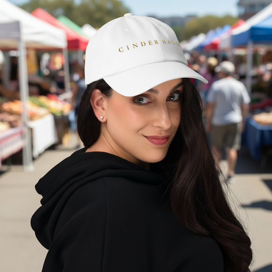 The Founder Cap in white — dad cap with gold CINDER HAUS embroidery, front view